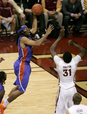 Florida's Alex Tyus shoots over Florida State's Chris Singleton in the first half of an NCAA college basketball game Sunday, Nov. 28, 2010, in Tallahassee, Fla.