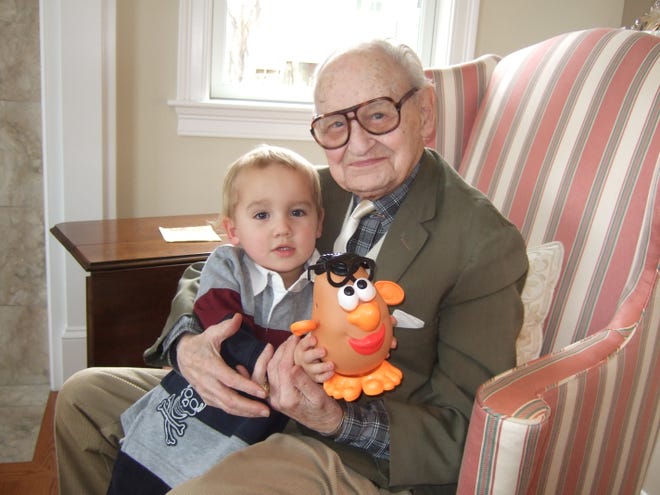 Thomas Robinson Sr., who turns 103 in January, holds great-grandson William Robinson, 3, on Thanksgiving Day in Sudbury.