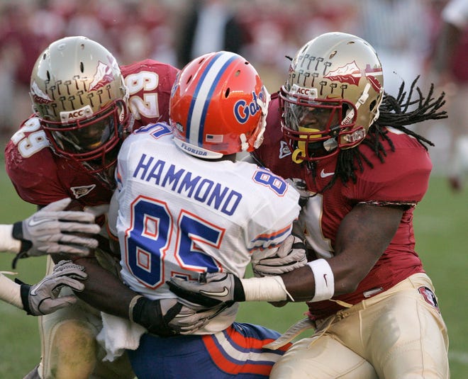Florida's Frankie Hammond is tackled by Florida State's Kendall Smith, left, and Terrance Parks Sunday during the second quarter. The Associated Press