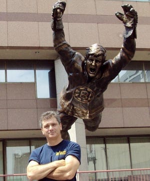 Dave Surette in Boston next to Bobby Orr statue.