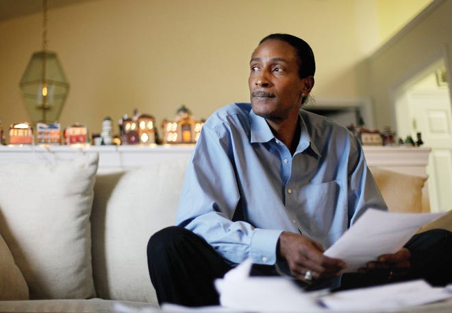 Wayne Pittman, 46, sits in his Lawrenceville, Ga., home looking over unemployment papers as his extended benefits are set to expire unless Congress passes a vote to extend them Tuesday, Nov. 30, 2010. Pittman, a carpenter, was working up to 80 hours a week at the beginning of the decade, but saw that gradually drop to 15 hours before it dried up completely. His last $297 unemployment benefit check will go to necessities, not Christmas presents.