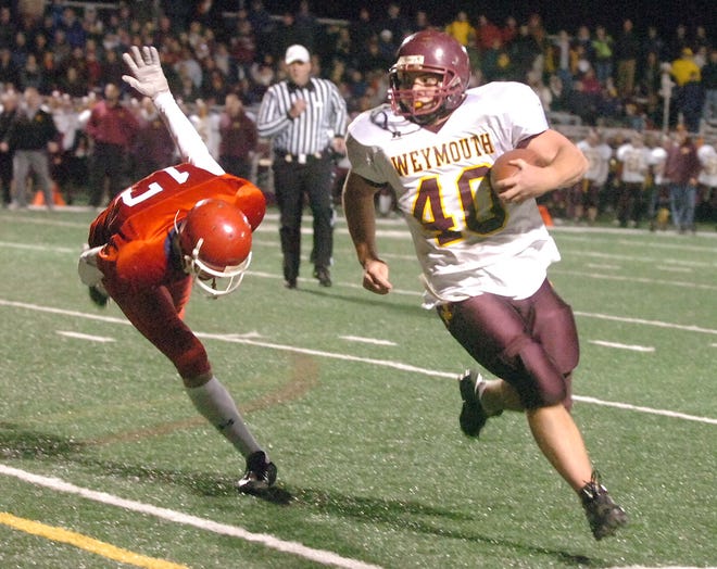 Weymouth's Dylan Colarusso, right, carries the football against Bridgewater-Raynham in the Division 1A playoff game.