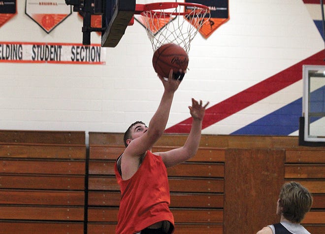 Belding’s Sean Heffron goes up for a layup during practice Tuesday afternoon. He is one of returning players from last year’s varsity boys basketball team.