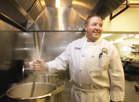 Galley Hatch executive chef Jeff Snyder stirs a pot in the kitchen.