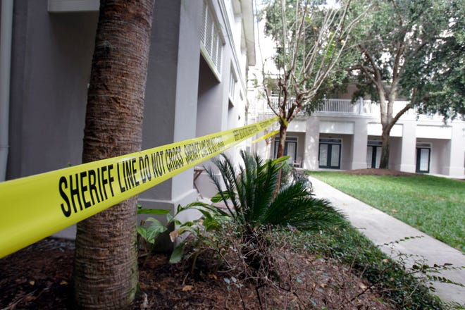 Crime tape blocks off a condominium in Celebration on Wednesday. Police are investigating the first murder in Celebration, the Disney-developed community.