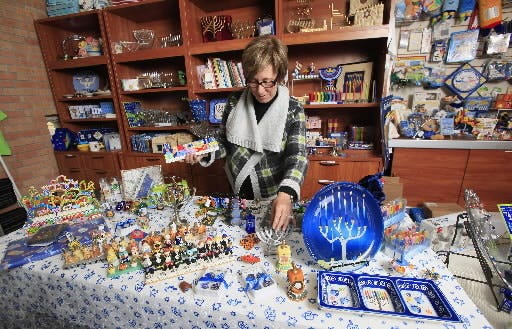 Volunteer Debbie Nevard arranging menorahs, dreidels and other items on display in the Judaica Shop at Temple B'nai Israel in Oklahoma City Tuesday, Nov. 30, 2010. Photo by Paul B. Southerland, The Oklahoman