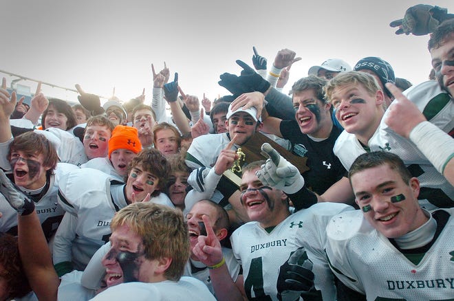 The Duxbury Dragons pose for photographs after their Super Bowl win over Concord-Carlisle at Gillette Stadium in Foxboro on Saturday, Dec. 4, 2010.