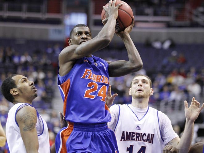 Florida's Casey Prather (24) shoots the ball past American's Troy Brewer, left, and Vlad Moldoveanu (14) during the second half of the Gators' 67-48 win.