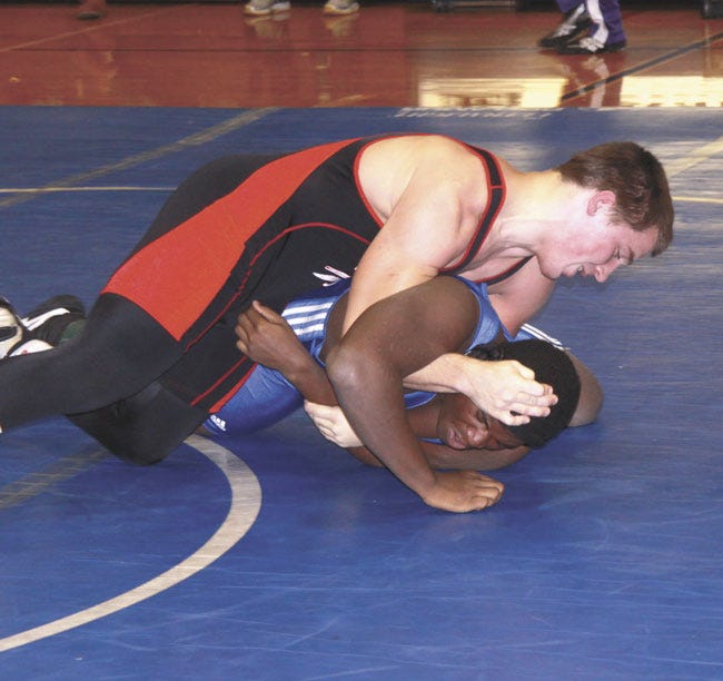 White Pigeon’s Holden Tullos gets a pin over Cassopolis’ Austin Pitchford Saturday at the Cassopolis Invitational. Tullos took first place at 285 with a 5-0 record.