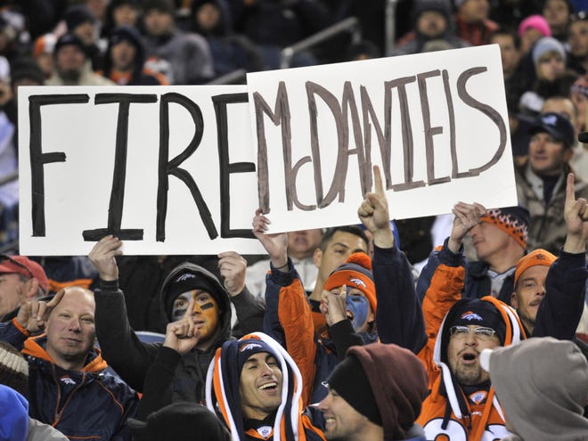 This Nov. 28, 2010 file photo shows fans holding a sign to fire Denver Broncos head coach Josh McDaniels during the second half of an NFL football game against the St. Louis Rams in Denver. The Denver Broncos fired McDaniels on Monday.
