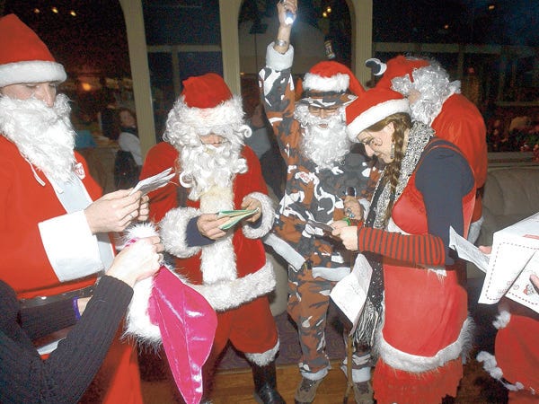 Some of the more than 30 santas involved in Wilmington's Santacon gather at Rossi's Piano Bar in 2005.