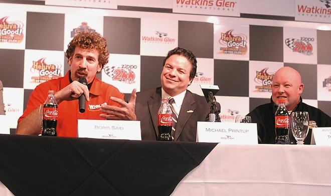 Race car driver Boris Said answers a question from the media as WGI track President Michael Printup and Craftsmen Truck driver Todd Bodine look on during a press conference announcing changes to the track.