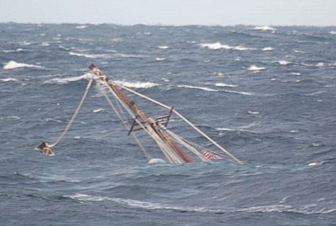 A mast of the 88-foot sailing vessel Raw Faith protrudes from the water as the boat sinks in approximately 6,000 feet of water about 166 miles southeast of Cape Cod, Mass., Wed., Dec. 8, 2010. The crew of the Kittery, Maine, Coast Guard Cutter Reliance remained on scene until the vessel sank. Coast Guard photo by Coast Guard Cutter Reliance crew.