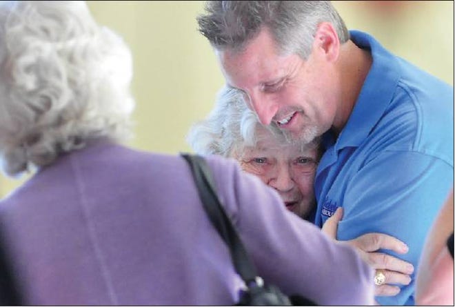 TRIBUTE LUNCHEON: The Boys and Girls Club of Victor Valley Executive Director Mark Sawyer, right, greets and hugs Mary Scarpa, 83, at a tribute luncheon Tuesday in Adelanto. More than 100 community members attended in honor of Scarpa's leadership and longtime devotion to Adelanto.
