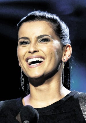 In this Nov. 11, 2010 file photo, Nelly Furtado accepts the award for best female pop vocal album for "Mi Plan" at the 11th Annual Latin Grammy Awards in Las Vegas.