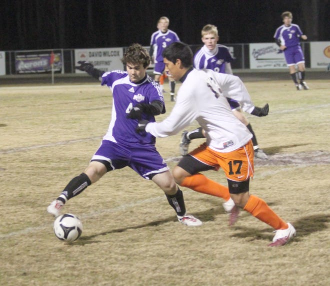 Dutchtown’s Aaron Henry battles for control of the ball against Catholic Wednesday night at Griffin Field.