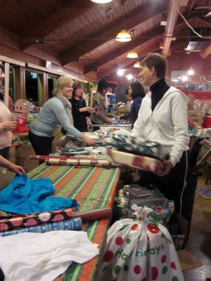 Volunteers help Scituate Community Christmas by wrapping donated presents on Wednesday, Dec. 8, 2010, at the Knights of Columbus hall.