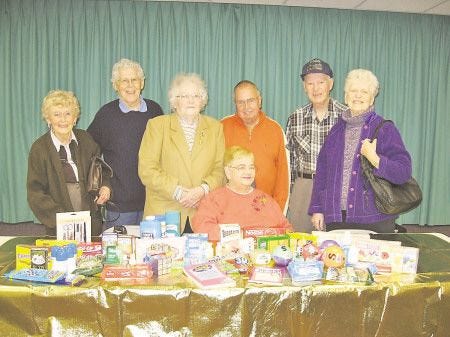 Courtesy photo
Several members of the Hampton Senior Citizens Club are pictured here with just a small collection of the many items the group donated to the Pease Greeters, who will ship the items in ìcare packagesî to US soldiers serving overseas. Pictured here are (from left) Maxine Delisle, Norman Delisle, Gerry Wilbur, Judy Ashenden (seated), Fred Ashenden (club president), Ed Stuckey and Grace Stuckey.