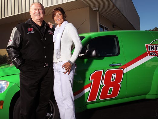 Stan and Donna Land of Interstate Battery pose outside their store in the Northwood Commercial Park Tuesday, December 7, 2010. The business has been operating for 30 years.