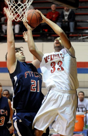 McKinley's Mike Mills scores and gets the foul on Austintown Fitch's David Anzelmo.