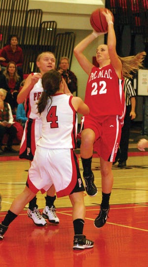 Brittany Monpere (22) drives the lane for Pal-Mac against Penfield defender Laura Wilkins in their game on Saturday afternoon at PHS. The Lady Raiders lost 67-35.