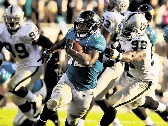 Jacksonville Jaguars running back Maurice Jones-Drew (32) scores on a 30-yard run against the Oakland Raiders during the fourth quarter of an NFL football game, Sunday, Dec. 12, 2010, in Jacksonville, Fla. Jaguars beat the Raiders 38-30.