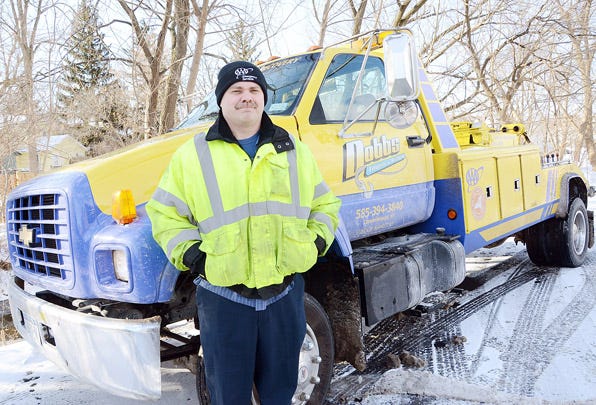 Rich Detro of Geneva is one of the two truck drivers for Dobbs Family Auto Service Inc. in Canandaigua. The season's first real snow kept tow truck drivers busy pulling people back on to the road.