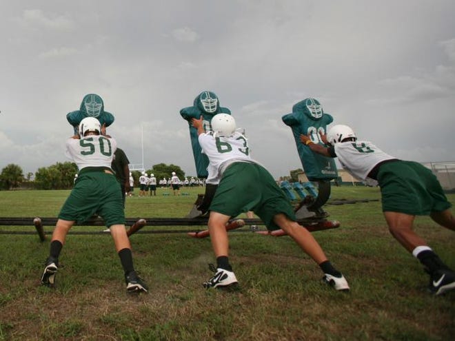 Venice players push practice dummies ahead of their first game in 2009. The team was forced to forfeit its games from that season.