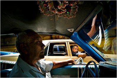 Julio Navas, a taxi driver, in his 1973 Dodge Coronet in Caracas, Venezuela.