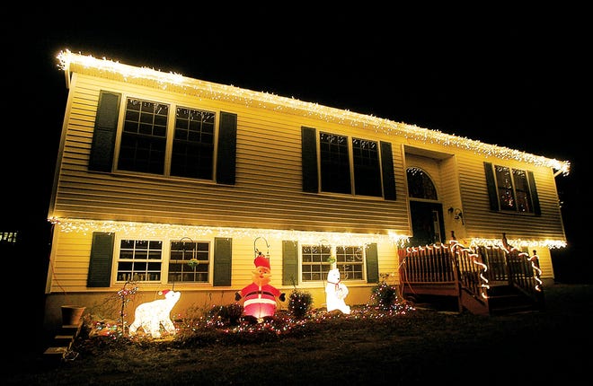 Photo by Daniel Freel/New Jersey Herald
 
The Stillwater home of Darlene and Steve Kepnes is lit up for the holidays Tuesday night. The Kepnes are competing in the first Stillwater Christmas light decorating contest and are submitted under the category of "Most Festive." The home is decorated with nearly 11 strings of lights and three standing characters.