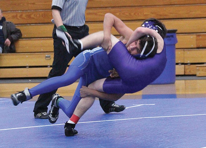 Ionia’s Tyler Ramos takes down his opponent from Fowlerville Tuesday night during the Bulldogs’ match against the Gladiators.