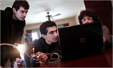 From left, brothers John, 18, and Anthony, 15, and their mother, Kathy Ceceri, with their Digital Blue QX5 microscope at their home in Schuylerville, N.Y.