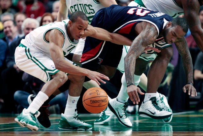 Boston Celtics guard Avery Bradley, right, gets control of the loose ball against Atlanta Hawks forward Josh Powell, right, during the first quarter of their NBA basketball game, Thursday, Dec. 16, 2010, in Boston. (AP Photo/Charles Krupa)
