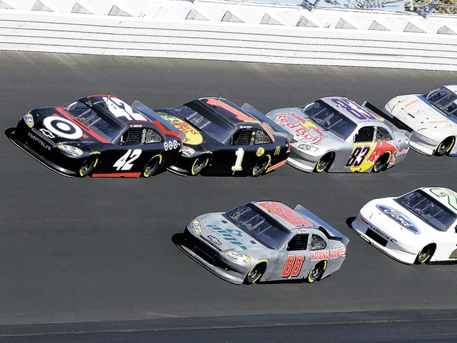 NASCAR Sprint Cup drivers Juan Pablo Montoya (42), of Colombia, Jamie McMurray (1), Reed Sorenson (83), Casey Mears (13), Dale Earnhardt Jr. (88) and Trevor Bayne (21) race around the newly-paved track surface at Daytona International Speedway in Daytona Beach, Fla., Thursday, Dec. 16, 2010. The testing was the first time race cars turned laps on the new asphalt.