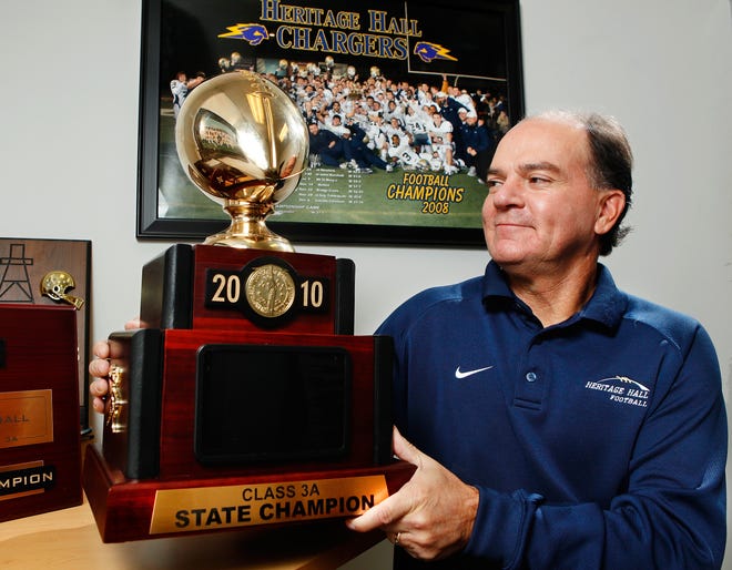 Andy Bogert, football coach at Heritage Hall High School, with this year's Class 3A State Championship trophy. Photo by Jim Beckel, The Oklahoman
