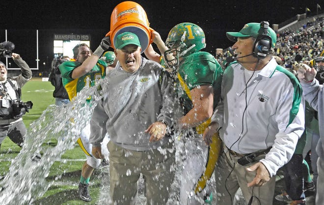 Idalou players douse head coach Johnny Taylor with water as the clock winds down to the end of their Class 2A Division II State Championship game Saturday at Vernon Newsom Stadium in Mansfield. Idalou beat Lexington 20-3 to claim the state title.