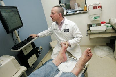 Photo by Daniel Freel/New Jersey Herald 
Dr. Marc Frankel, of Frankel Foot & Ankle, works with a patient in his Milford, Pa., office.