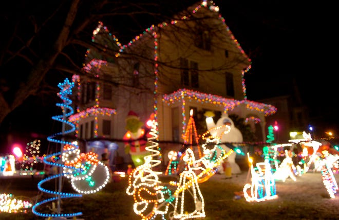 Laurie Willis’ display on Broad Street in Whitman lights her yard Monday evening. The neighbors have been going all-out on decorations in a friendly competition of holiday spirit.


(J. KIELY JR./THE ENTERPRISE)
