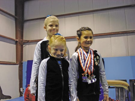 Atlantic gymnasts Victoria Ross (back), Katherine Carter and Ayla McKean were among those who had success at a recent home meet in Portsmouth.