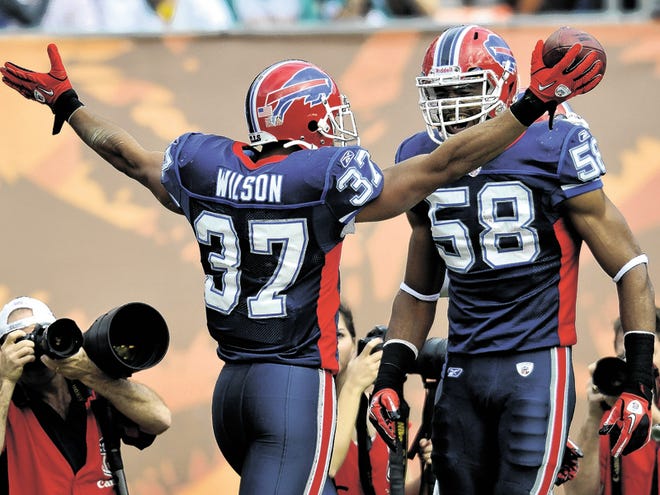 Buffalo Bills' George Wilson (37) and Aaron Maybin (58) celebrate after Wilson intercepted a Miami Dolphins pass during the first half of an NFL football game in Miami, Sunday, Dec. 19, 2010.