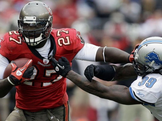BUCS RUNNING BACK LeGarrette Blount (27) stiff-arms Detroit safety C.C. Brown during Sunday's game in Tampa.