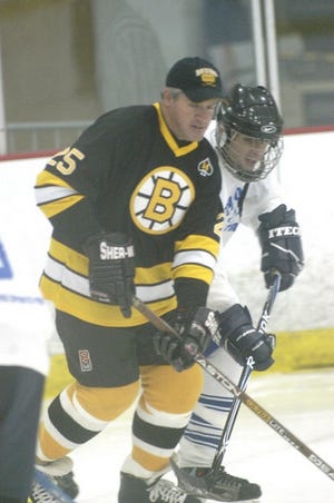 Ken Stejbach photo
Boston Bruins Alumni player Andy Brickley mixes it up with Stratham’s Drew Smith of the Seacoast All-Stars during Saturday’s action at The Rinks at Exeter.