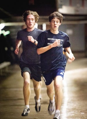 John Carden photo
Winnacunnet High School long distance runners Caemen Weiland, left, and Austin Power run laps during a recent practice at Phillips Exeter Academy.