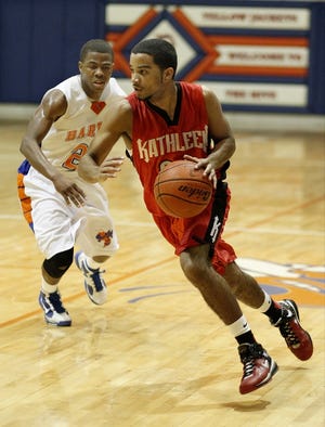 KATHLEEN'S MOISES RODRIGUEZ, here dribbling past Bartow's Weedlens Beauvil in the 2009-10 playoffs, made a last-second shot to beat the Yellow Jackets on Dec. 16.