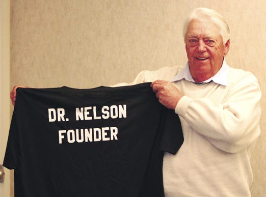 Dr. James Nelson, DDS, and founder of Associated Dentists, Pontiac, was back in Pontiac on Tuesday and visited his former office where he was presented with this special shirt that proclaimed him “Dr. Nelson Founder.” Associated celebrated its 40th anniversary, earlier this fall, and Nelson wasn’t able to get back then to join the celebration. Nelson left the practice in 1992 and retired to Florida.