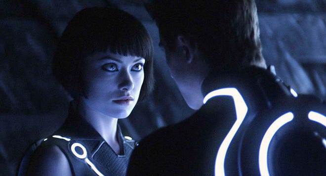 Olivia Wilde, left, and Garrett Hedlund star in a scene from “Tron: Legacy.”