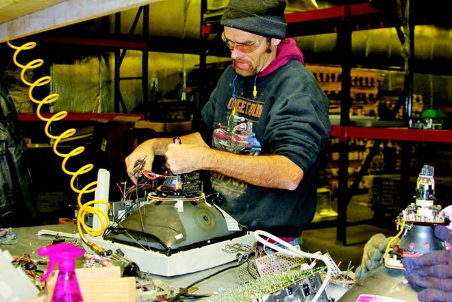 Jimmy Hathaway is one of about six consumers trained so far to disassemble electronics for Warren Achievement Center.