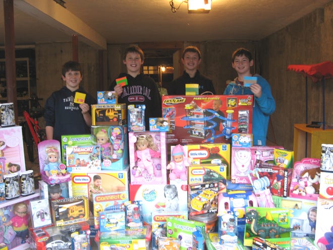 Alex Sullivan, Chris Tulley, Travis Metcalf and Sammy O'Connor have collected these toys for needy children.
