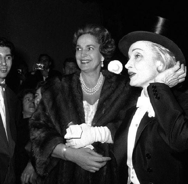 Marlene Dietrich wears a tuxedo and top hat at a Paris premiere in 1959. Formal menswear was the performer’s signature look.