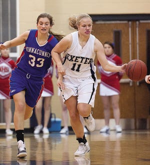 John Carden photo
Exeter’s Michaela Janowski, right, dribbles past Winnacunnet’s Carly Gould during Tuesday night’s Division I girls basketball game in Exeter.